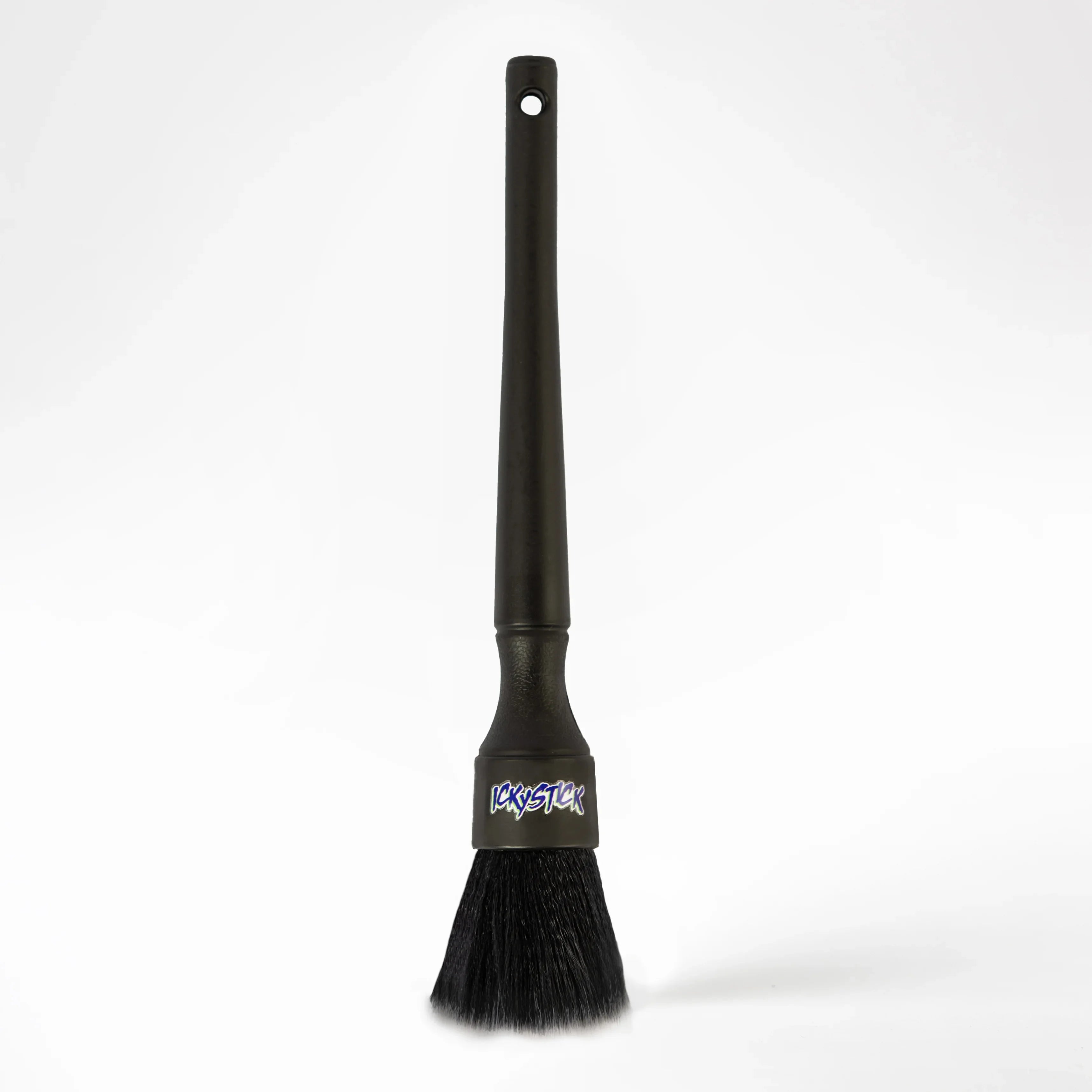Black detailing brush for car cleaning with long handle and soft bristles on white background.