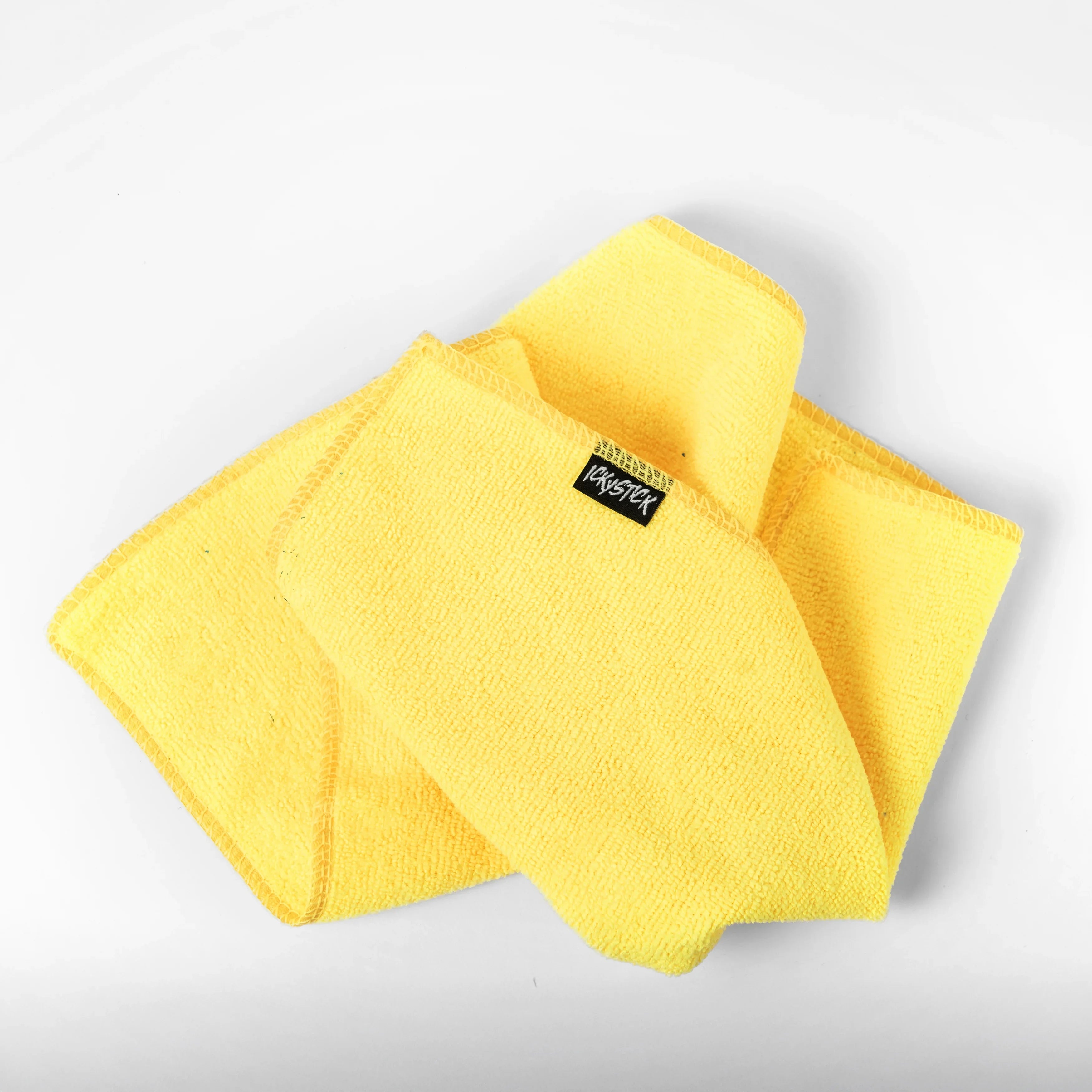 Yellow microfiber car cleaning cloth on white background, suitable for auto detailing.